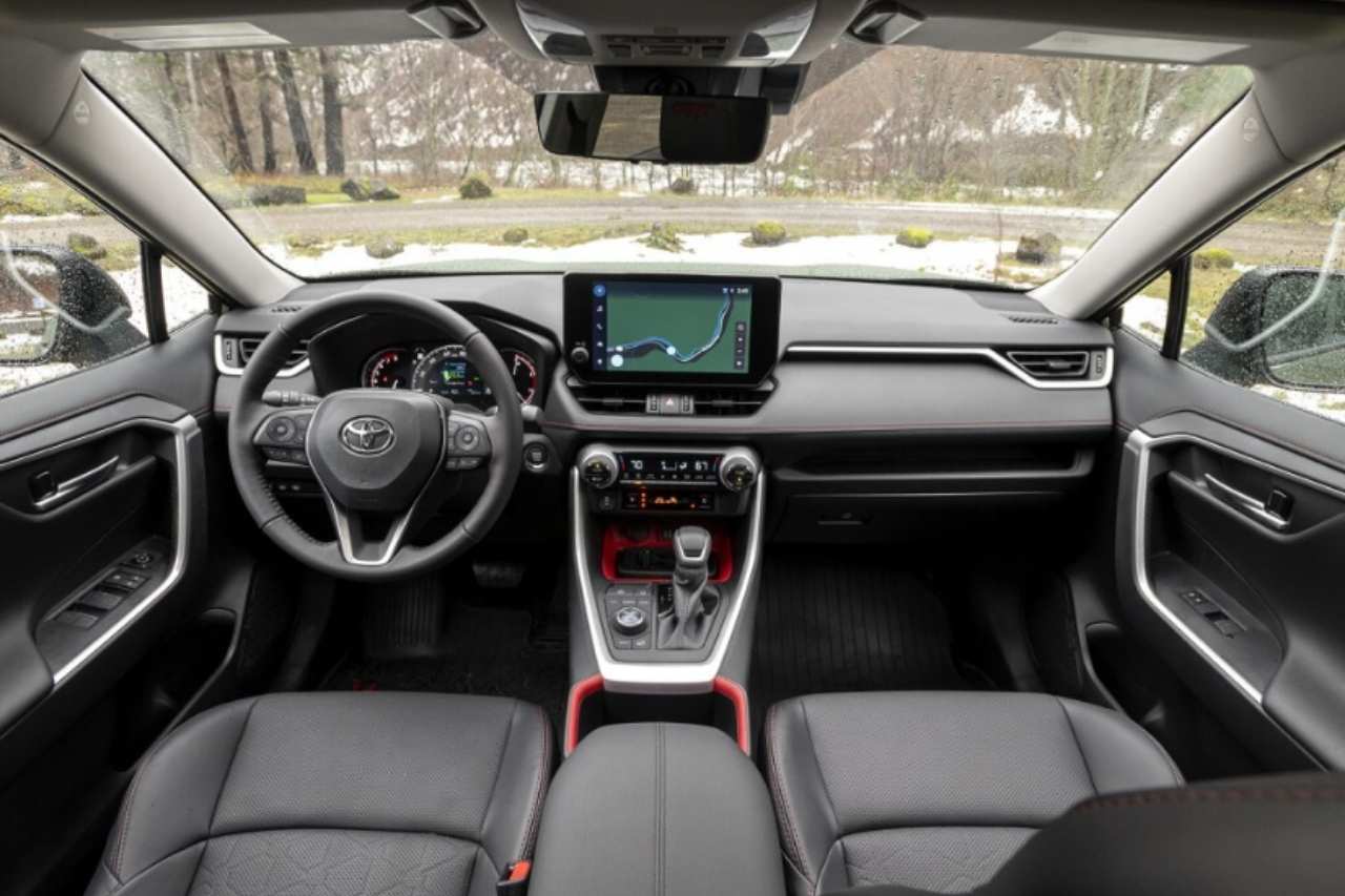 The black interior of a 2024 Toyota RAV4 SUV, looking out the windshield window.