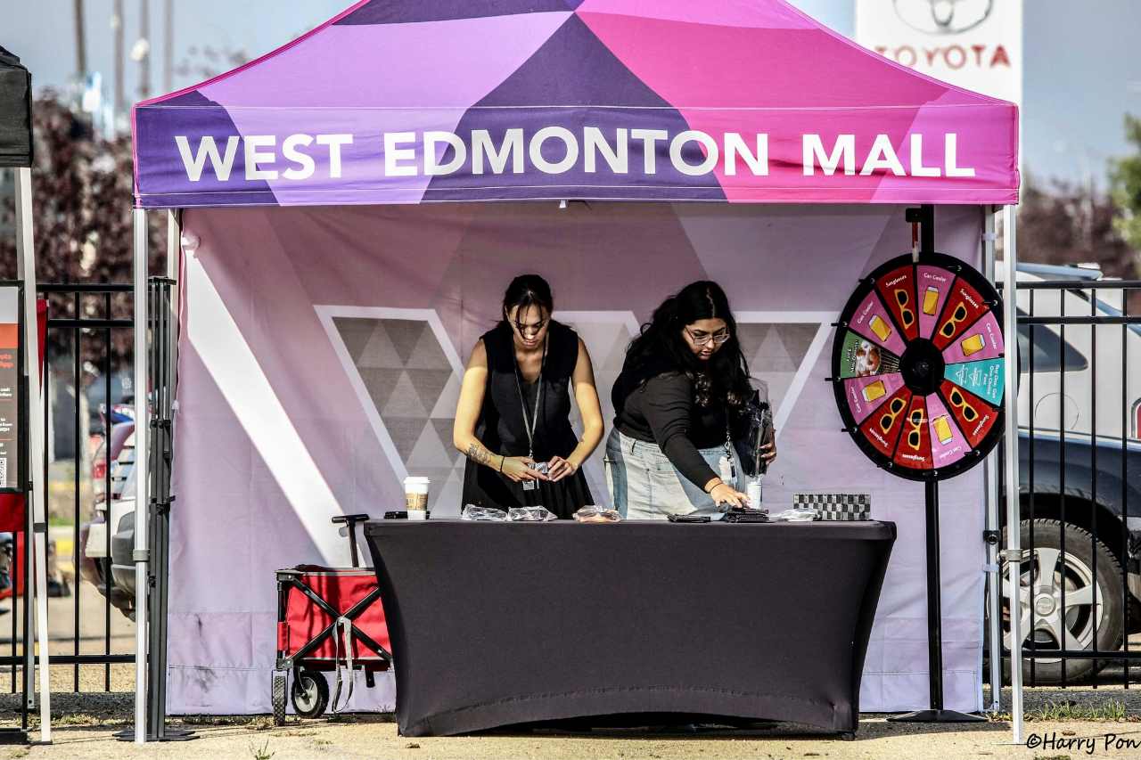 The West Edmonton Mall stand at the car show, with volunteers giving out prizes to attendees.