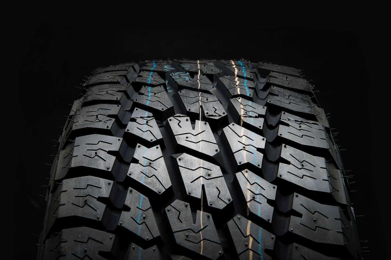 A close-up shot of the tire tread and grooves on a Toyota winter tire.