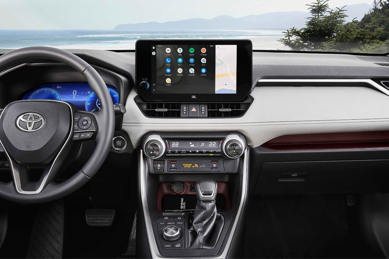 An interior view of the 2025 RAV4 interior with the multimedia screen, heated steering wheel and tech features.