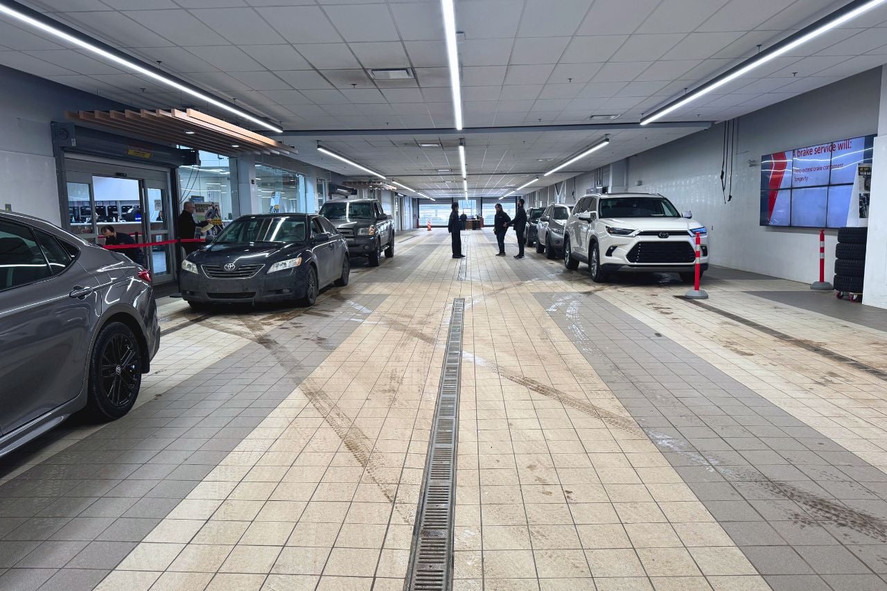 The interior of the service drive-thru bay at West Edmonton Mall Toyota, offering express oil changes with no appointment required.