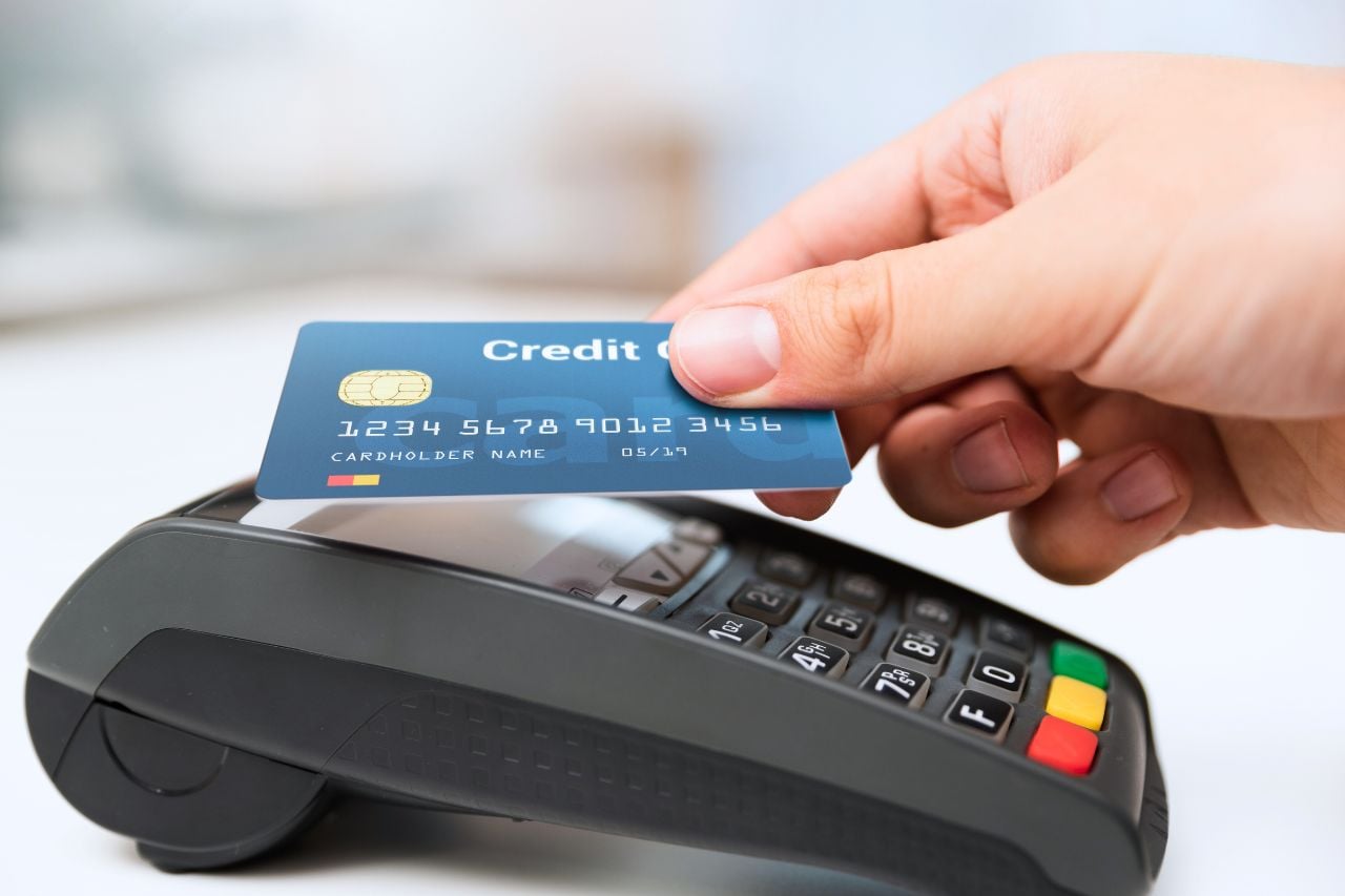 A person taps their credit card on a payment terminal.