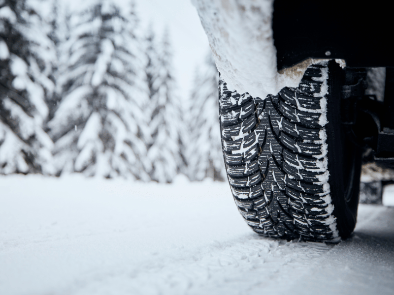 snow covered tire on icy road