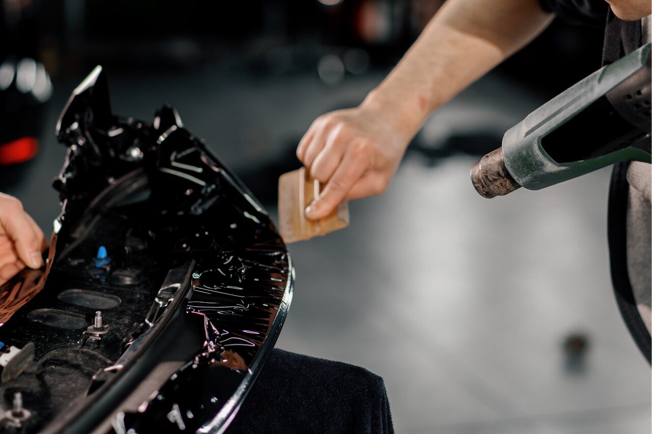 technician inspecting car part