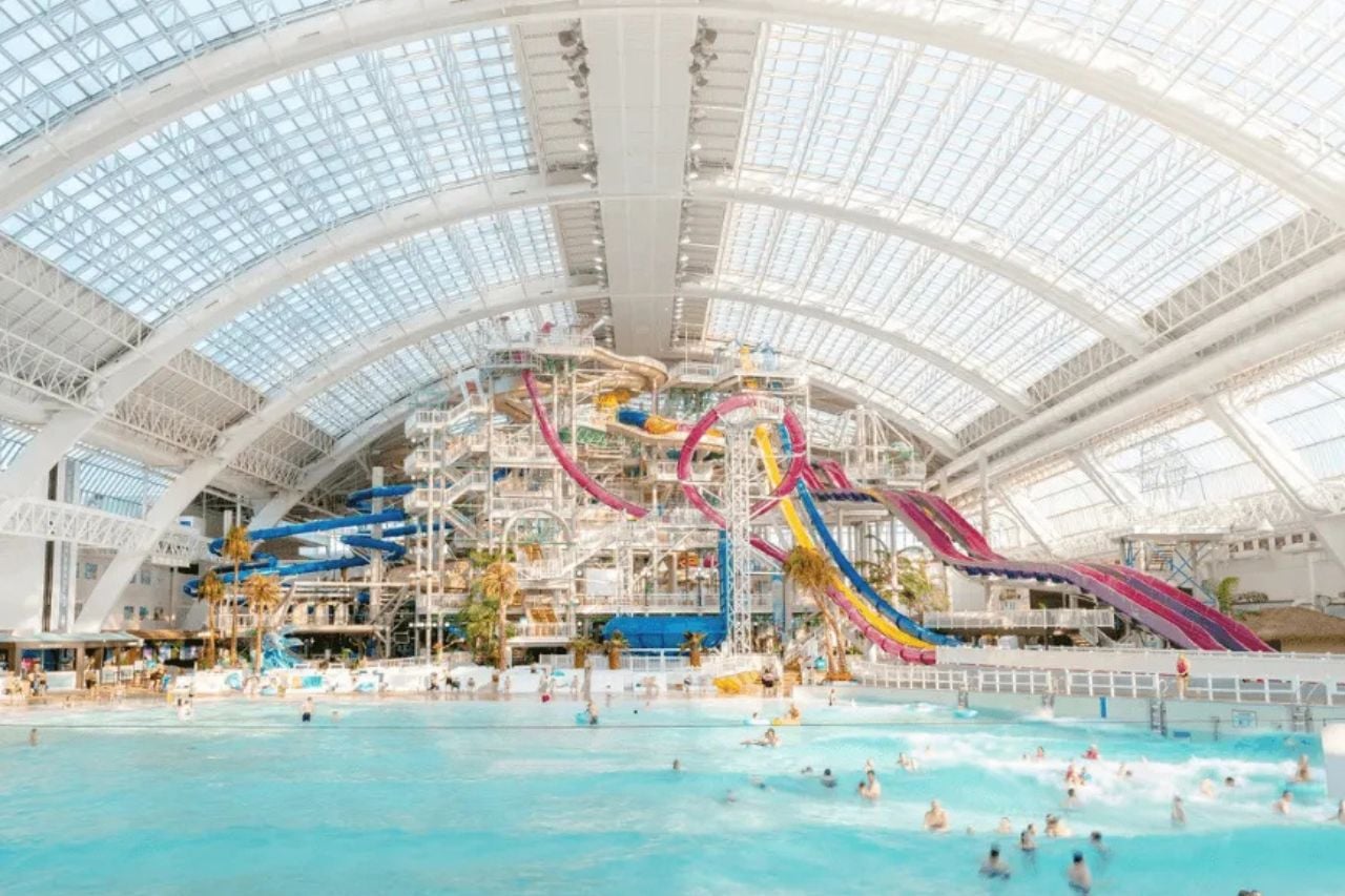 The interior of World Waterpark in West Edmonton Mall, with a large pool and tall waterslides.