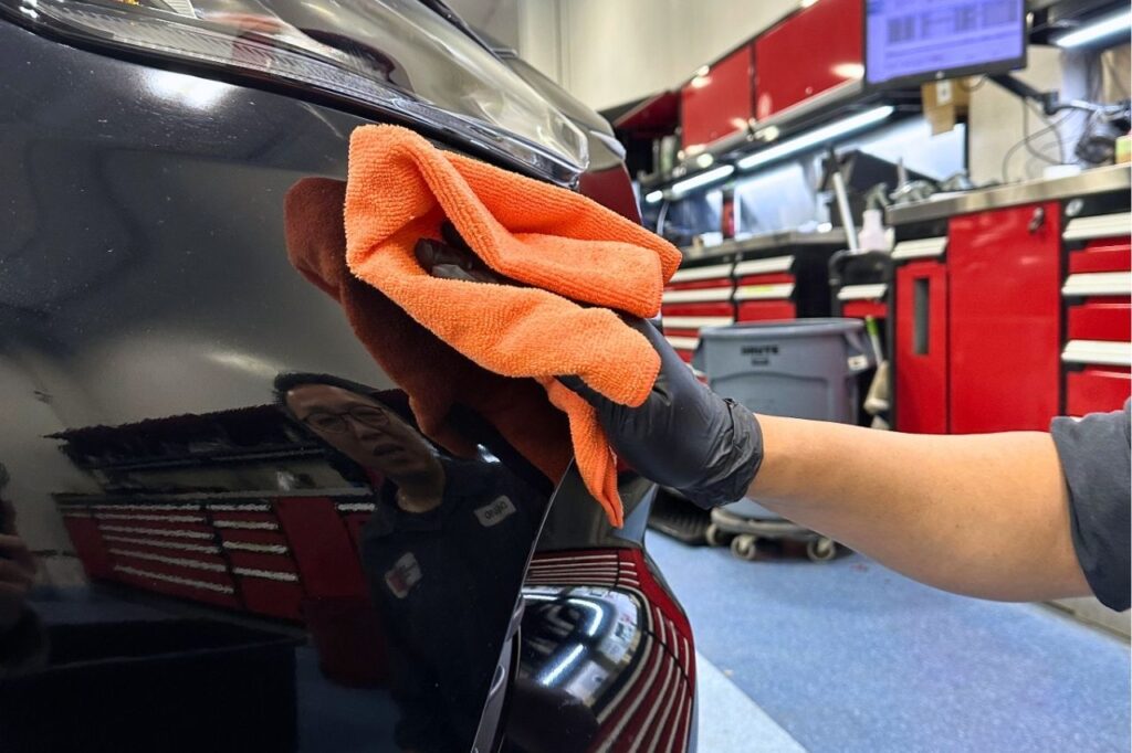 A Toyota detailer at West Edmonton Mall uses a microfibre cloth to clean and polish the exterior of a vehicle.