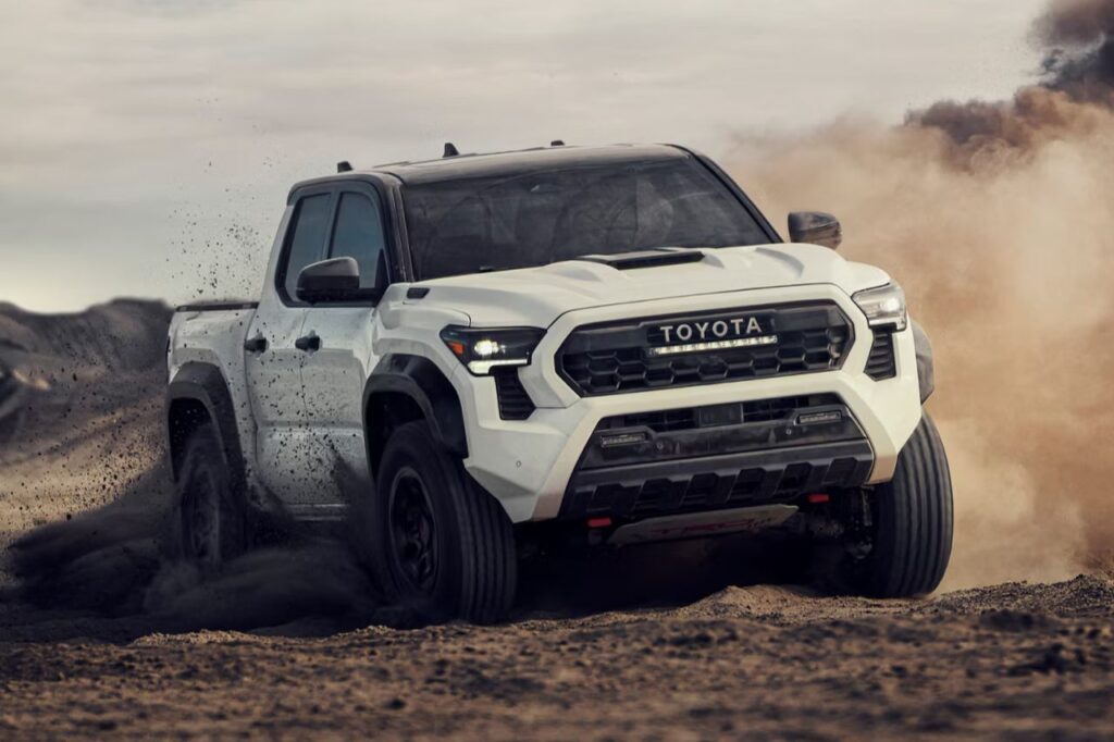 The Best Toyotas for Dads-4 A white Toyota truck drives and drifts through some loose dirt on an offroading adventure.