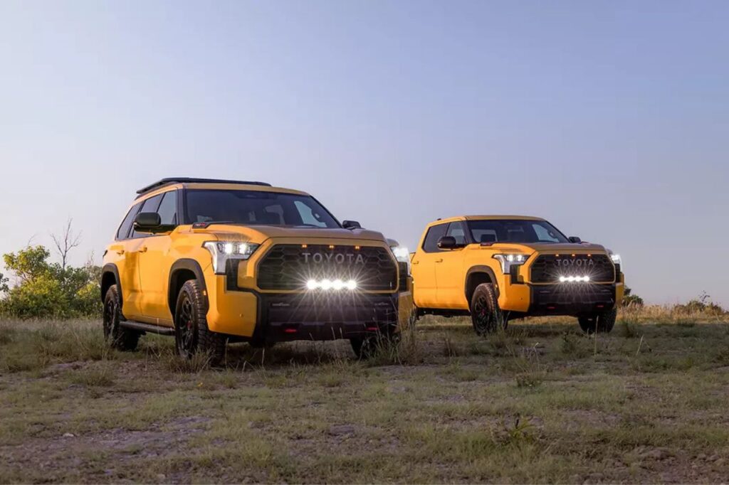 Pictured in the exclusive Honeycomb shade for 2027, the Toyota Sequoia and Tundra stand on a grassy hill at dusk.