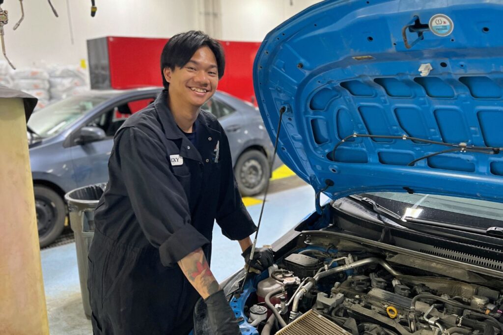 Back-to-School Shopping at West Edmonton Mall-3 Ricky, a West Edmonton Mall Toyota technician, performs an oil change on a vehicle in the service department.