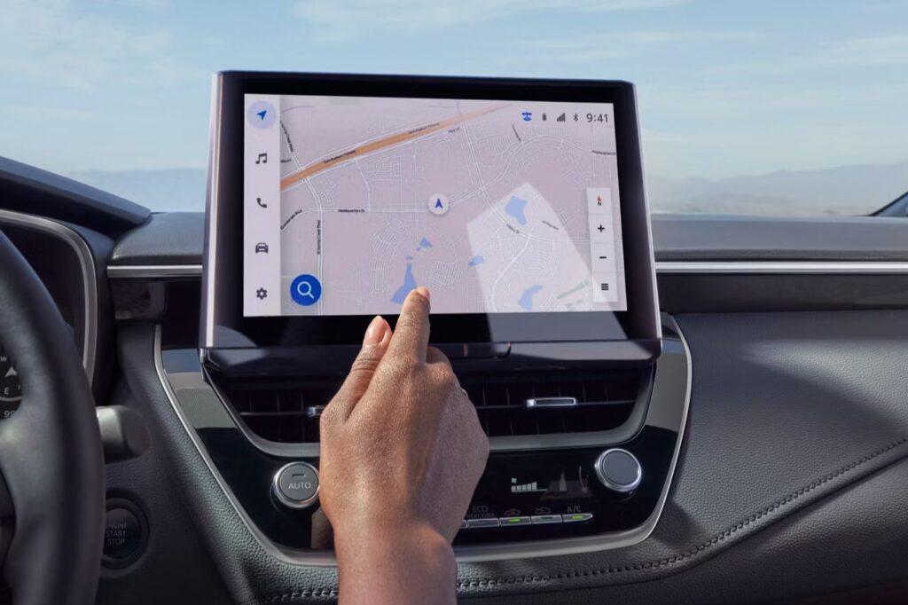 The 2027 Toyota Corolla Hatchback Is Here -2 An African American woman uses the touchscreen in the 2027 Toyota Corolla Hatchback XSE.